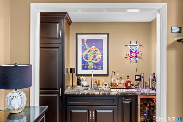a view of a kitchen with stainless steel appliances granite countertop a sink and cabinets