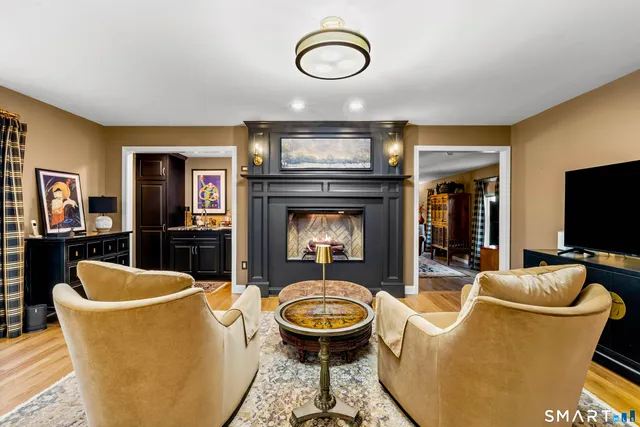 a living room with furniture a flat screen tv and rug
