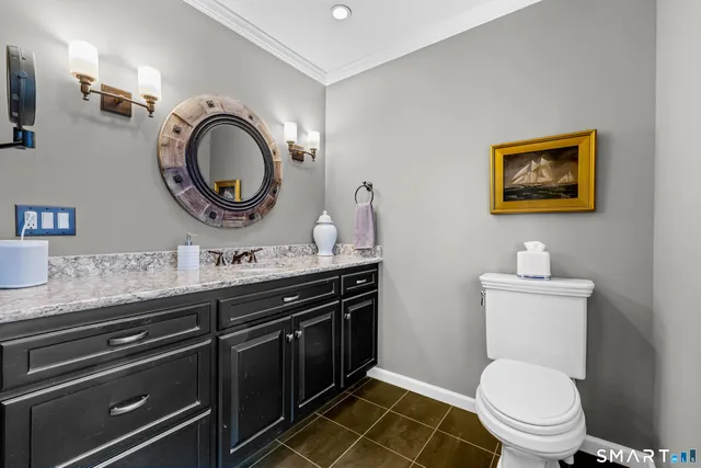 a bathroom with a toilet a sink and a mirror
