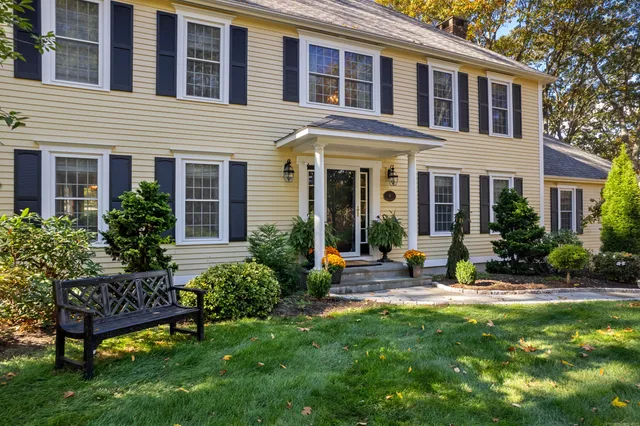 a view of a house with a yard and sitting area