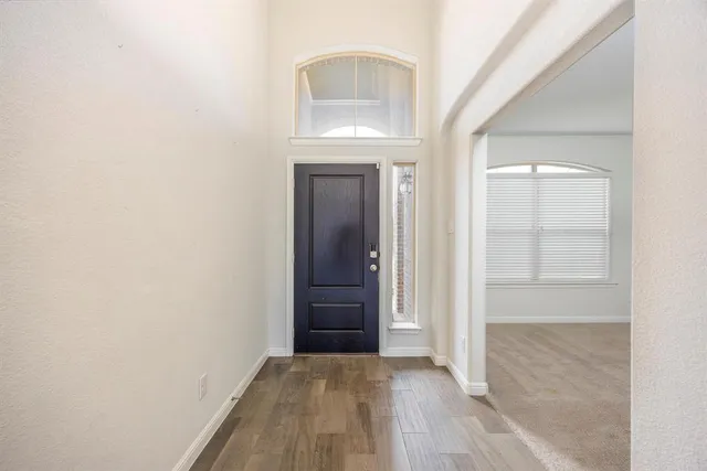 an empty room with closet and windows