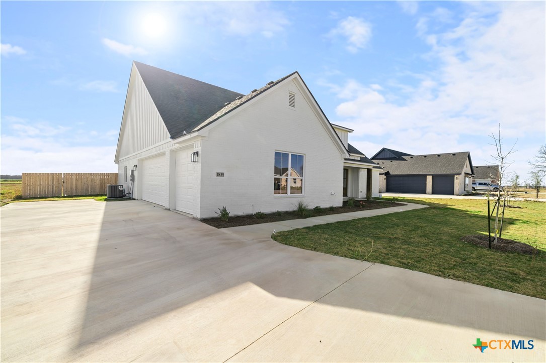 1835 Ember Drive Temple, TX 76502 - Photo 24 of 44 a view of a white house next to a yard and road