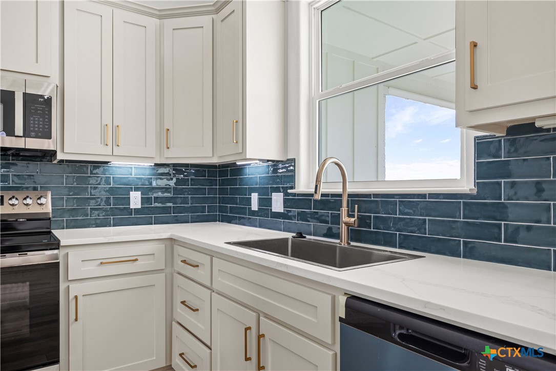 1835 Ember Drive Temple, TX 76502 - Photo 7 of 44 a kitchen with a sink cabinets and stainless steel appliances