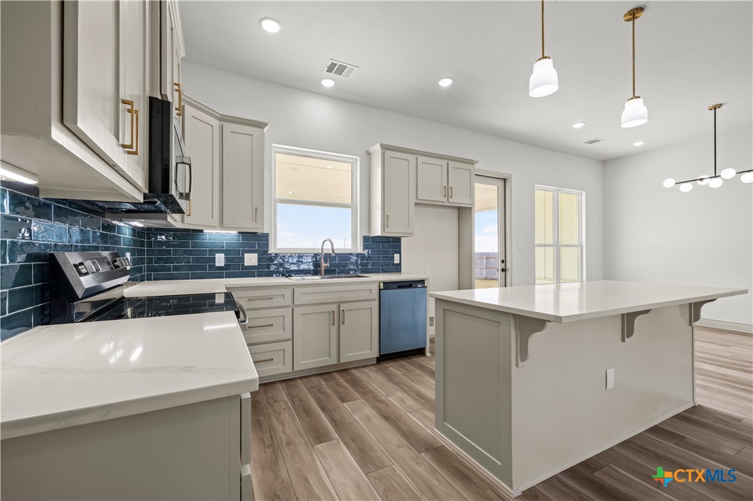 1835 Ember Drive Temple, TX 76502 - Photo 8 of 44 a kitchen that has a lot of cabinets in it and wooden floor