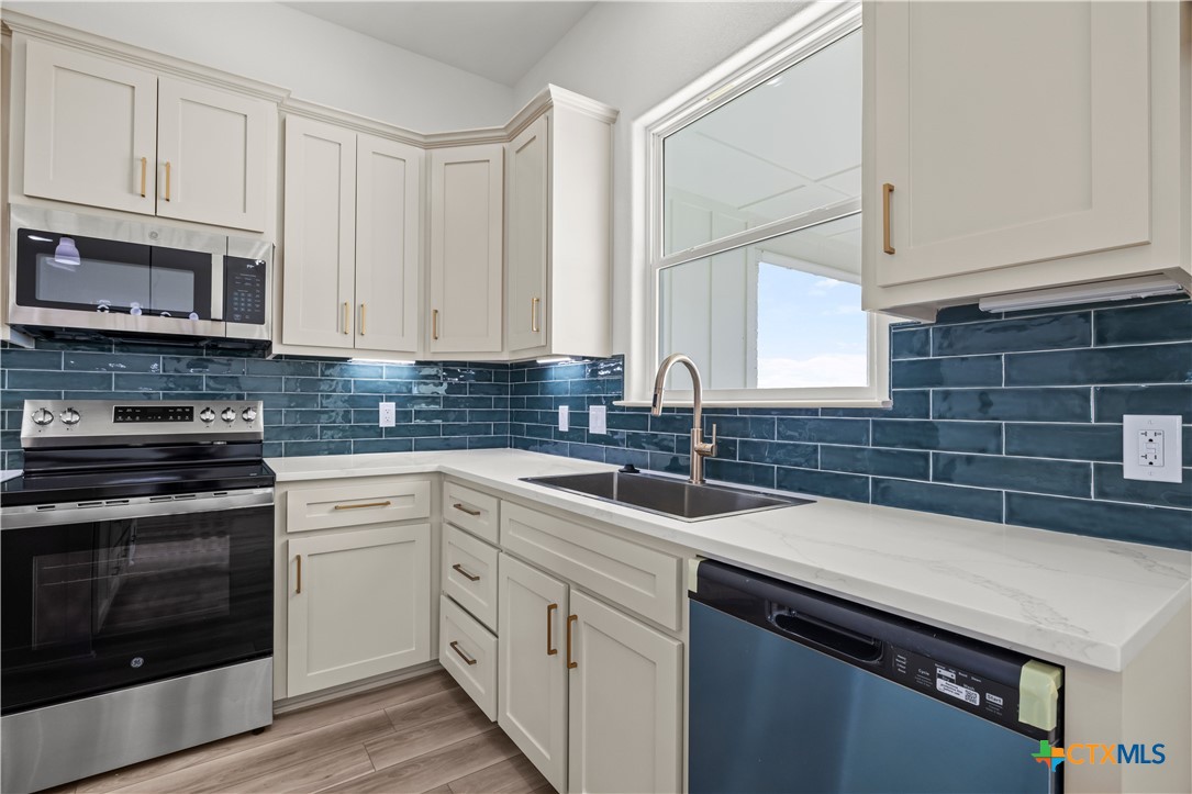 1835 Ember Drive Temple, TX 76502 - Photo 9 of 44 a kitchen with stainless steel appliances granite countertop a sink a stove and cabinets