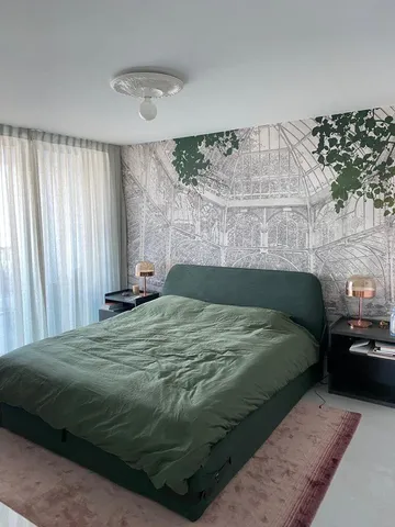 a bed sitting in a bedroom next to a window