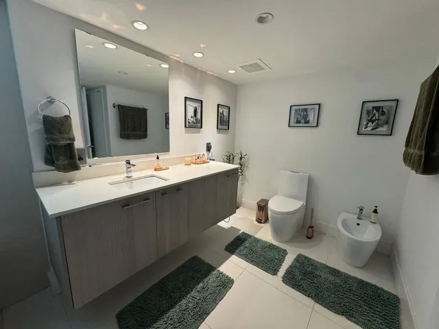 a spacious bathroom with a double vanity sink and a mirror