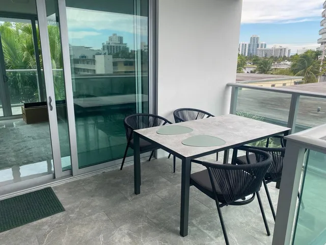 a view of a balcony with two chairs and a table