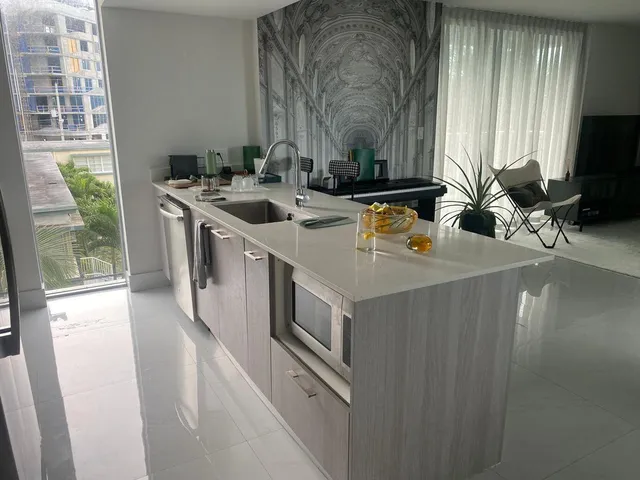 a kitchen with stainless steel appliances a sink stove and cabinets