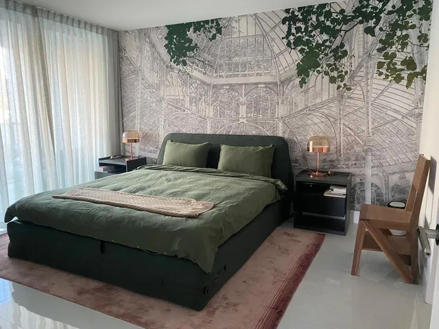 a bedroom with a bed chair and a window