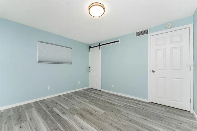 a view of a patio with a table and chairs under an umbrella