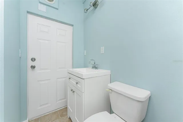 a view of a porch with a table and chairs
