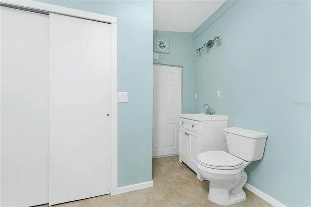 a view of a water with boats and trees in the background