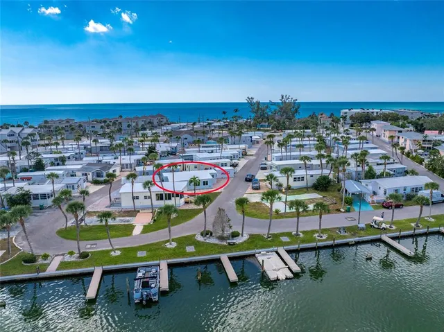 a kitchen with stainless steel appliances granite countertop a stove a sink dishwasher and a microwave oven with white cabinets