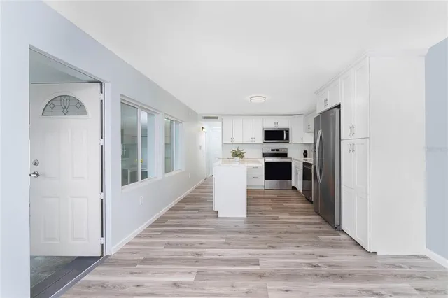 a kitchen with a sink stove and cabinets