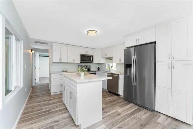 a view of a livingroom with a ceiling fan and window
