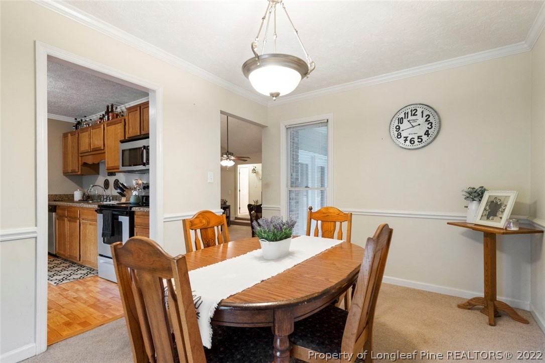 114 Windsor Lane Raeford, NC 28376 - Photo 11 of 32 a view of a dining room with furniture and chandelier
