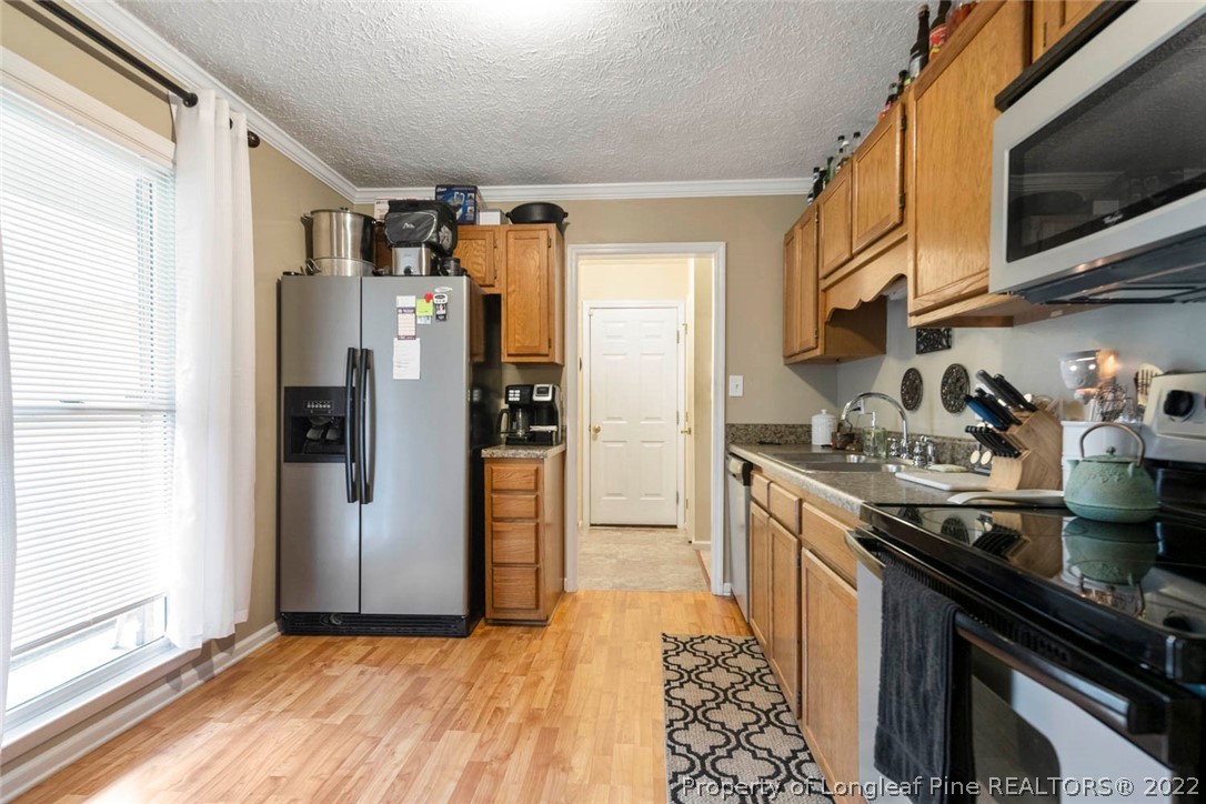 114 Windsor Lane Raeford, NC 28376 - Photo 12 of 32 a kitchen with stainless steel appliances granite countertop a refrigerator and a stove top oven