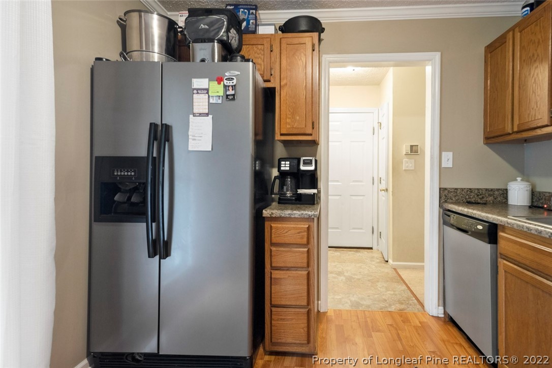 114 Windsor Lane Raeford, NC 28376 - Photo 13 of 32 a kitchen with stainless steel appliances granite countertop a refrigerator and a stove top oven