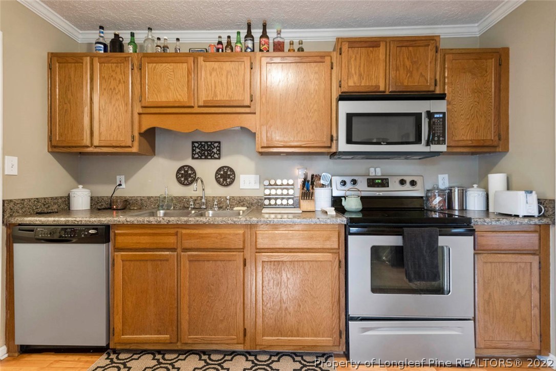 114 Windsor Lane Raeford, NC 28376 - Photo 14 of 32 a kitchen with stainless steel appliances granite countertop a stove a sink and a microwave