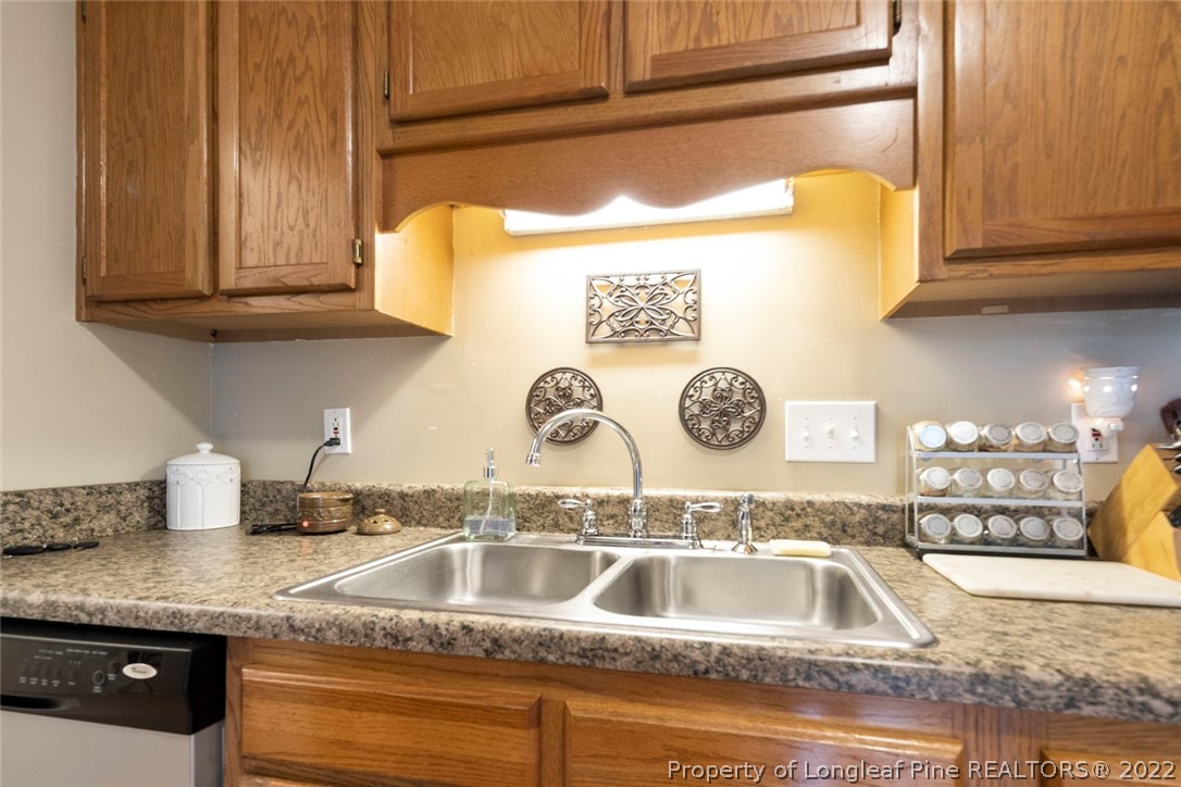 114 Windsor Lane Raeford, NC 28376 - Photo 15 of 32 a kitchen with granite countertop a sink and a stove