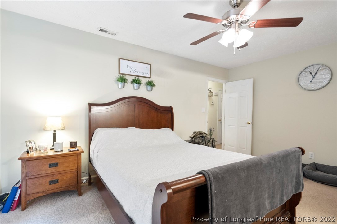 114 Windsor Lane Raeford, NC 28376 - Photo 23 of 32 a bedroom with a bed and a chandelier