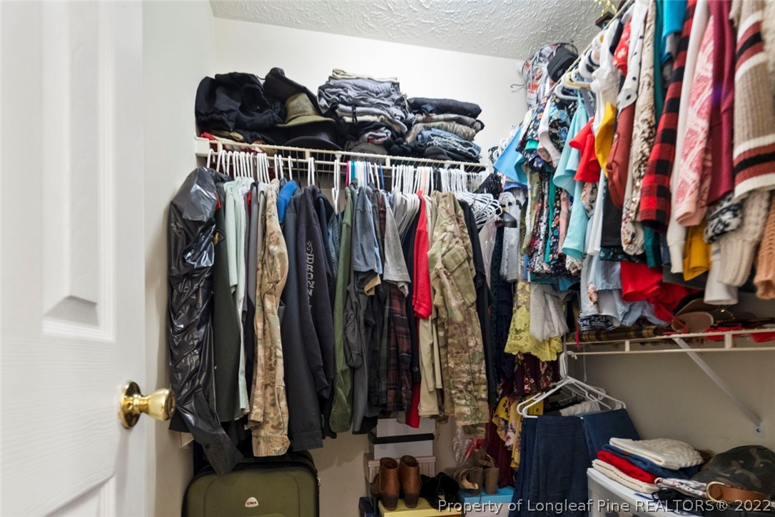 114 Windsor Lane Raeford, NC 28376 - Photo 27 of 32 a view of walk in closet with clothes and shoes