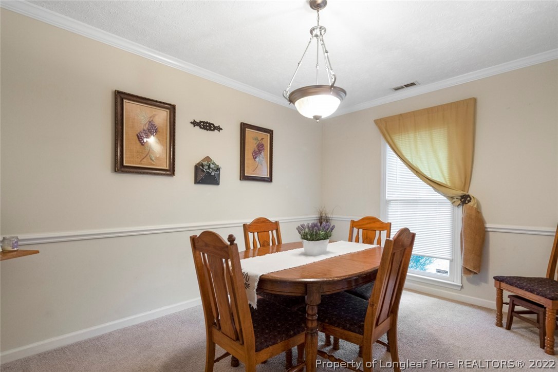 114 Windsor Lane Raeford, NC 28376 - Photo 10 of 32 a view of a dining room with furniture window and wooden floor