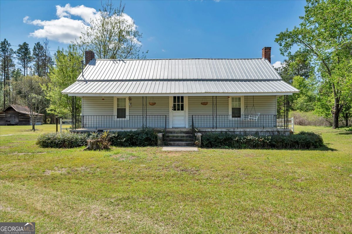 3613 S Highway Dublin, GA 31021 - Photo 1 of 52 a front view of a house with a yard