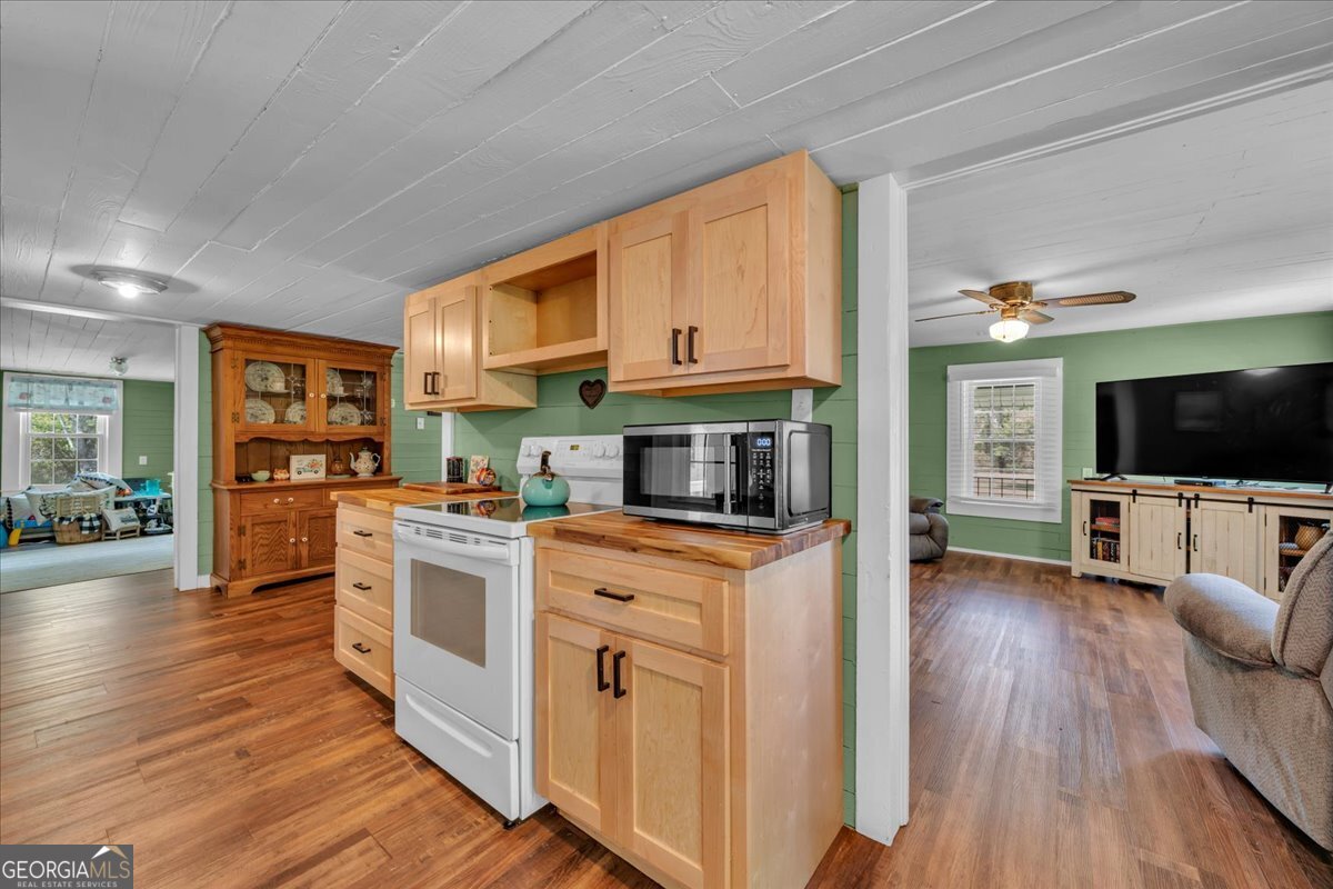 3613 S Highway Dublin, GA 31021 - Photo 13 of 52 a kitchen with stainless steel appliances granite countertop a stove top oven a sink dishwasher and a microwave oven with wooden floor
