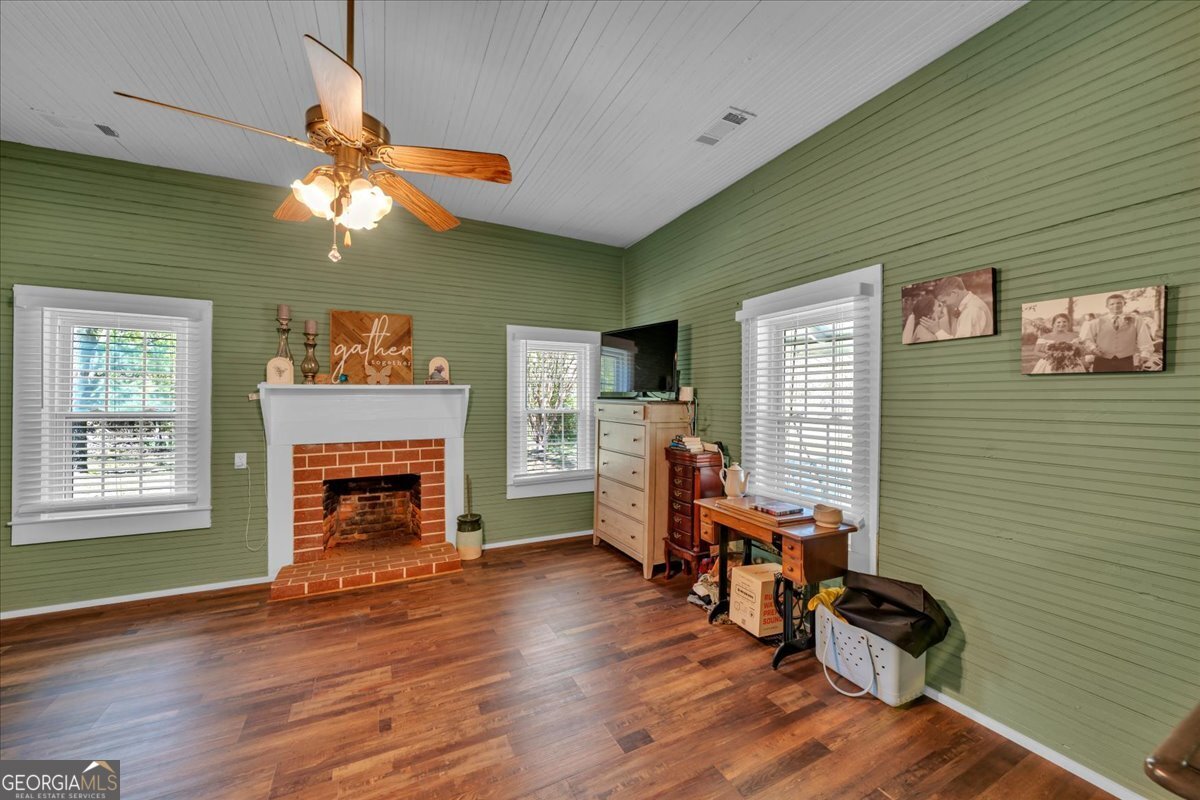 3613 S Highway Dublin, GA 31021 - Photo 17 of 52 a living room with furniture and a fireplace