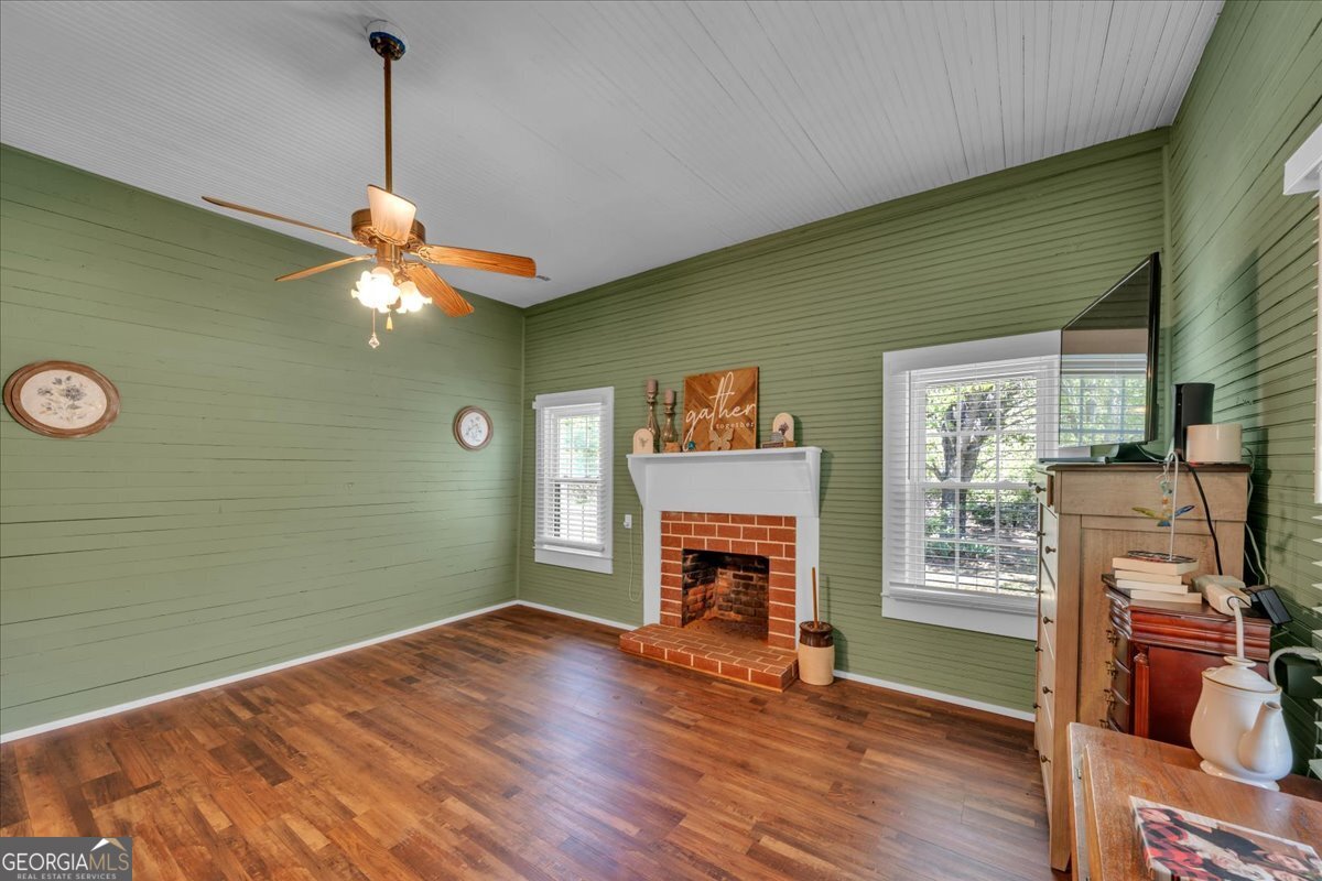 3613 S Highway Dublin, GA 31021 - Photo 18 of 52 a view of a livingroom with a fireplace a window and wooden floor