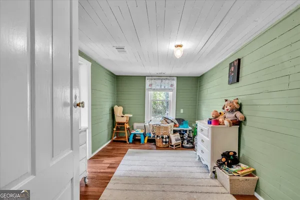 a living room with furniture gym equipment and a window