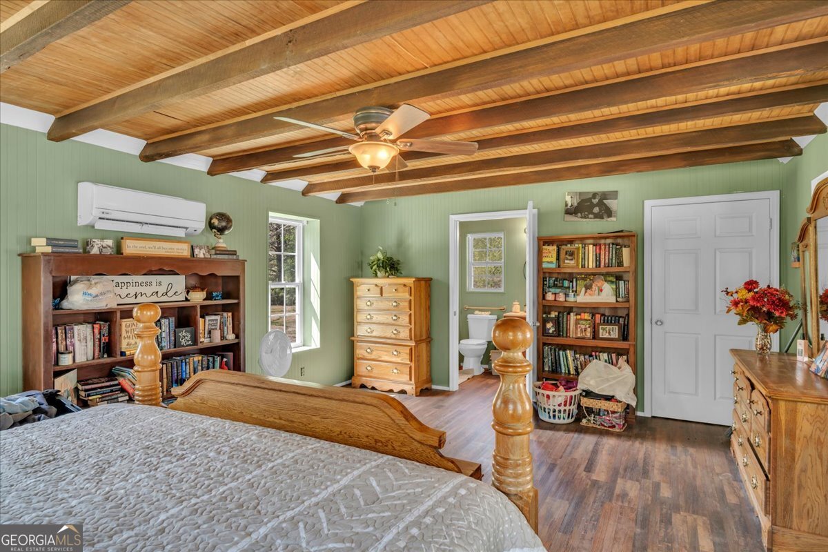 3613 S Highway Dublin, GA 31021 - Photo 32 of 52 a bedroom with a bed a table and bookshelf