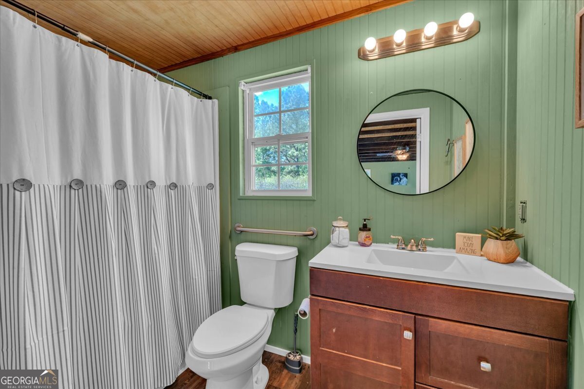 3613 S Highway Dublin, GA 31021 - Photo 34 of 52 a bathroom with a toilet a sink and mirror