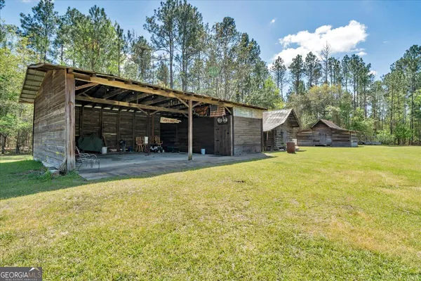 a front view of house with yard outdoor seating and barbeque oven