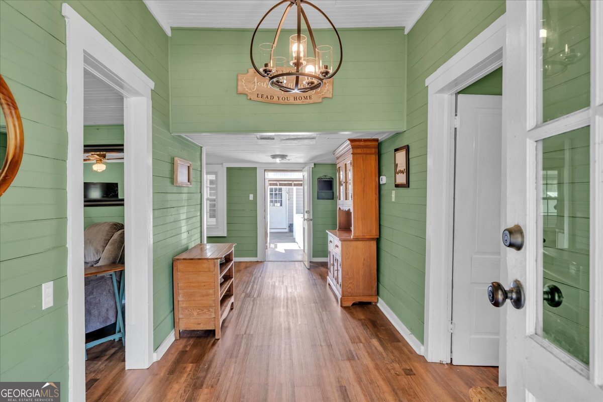 3613 S Highway Dublin, GA 31021 - Photo 6 of 52 a view of a hallway with wooden floor and a chandelier