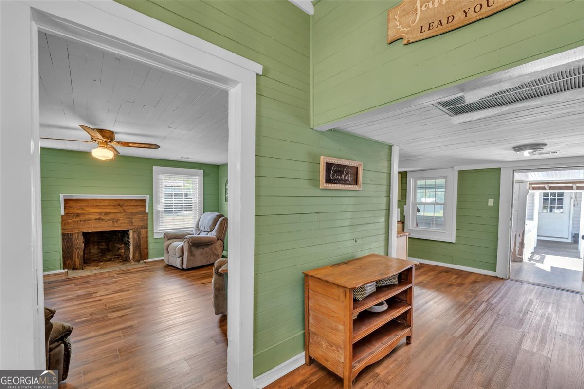 3613 S Highway Dublin, GA 31021 - Photo 7 of 52 a backyard of a house with furniture a fireplace and wooden floor