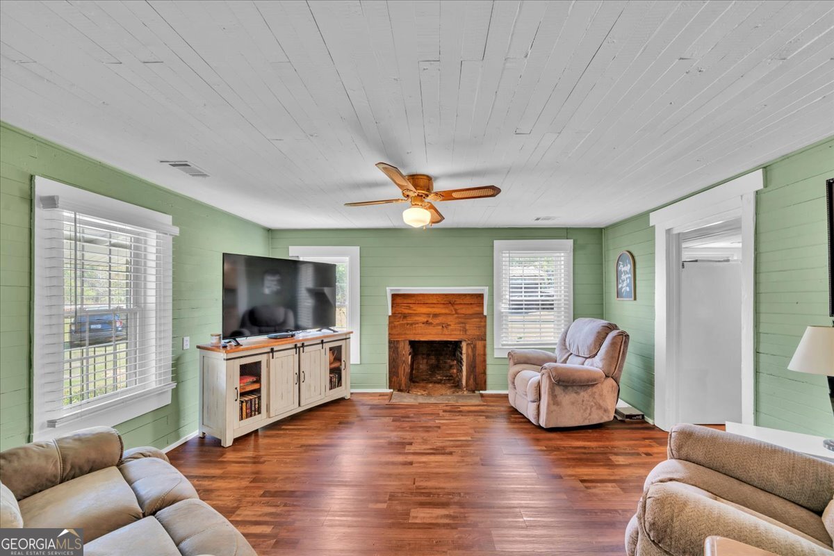 3613 S Highway Dublin, GA 31021 - Photo 9 of 52 a living room with furniture flat screen tv and wooden floor