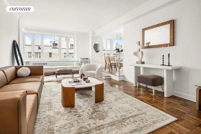 a living room with furniture a rug and a table