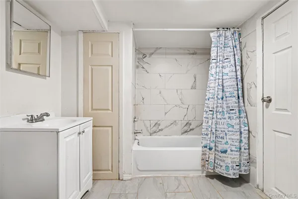 a bathroom with a bathtub a sink and a shower