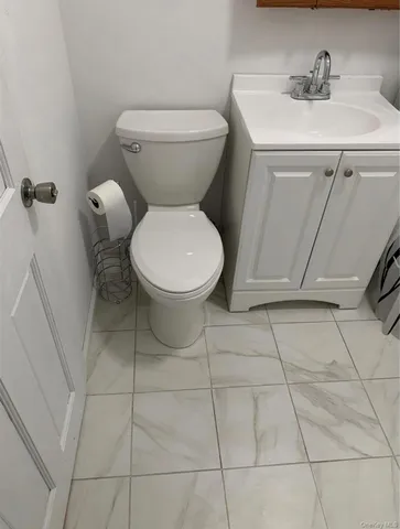 a view of an empty room with a chandelier fan