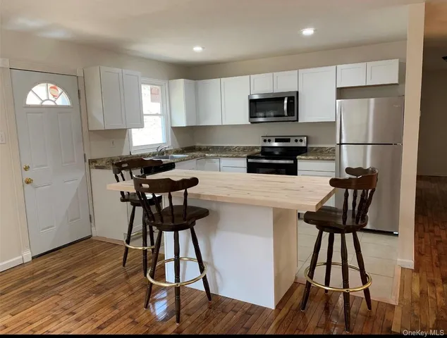 a kitchen with a stove a sink and a microwave