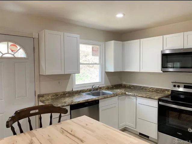 a view of a room with wooden floor and window