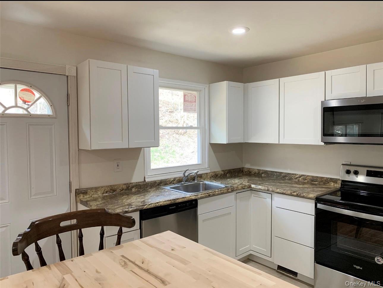 604 Basket Road Long Eddy, NY 12760 - Photo 24 of 37 a kitchen with a stove a sink and a microwave
