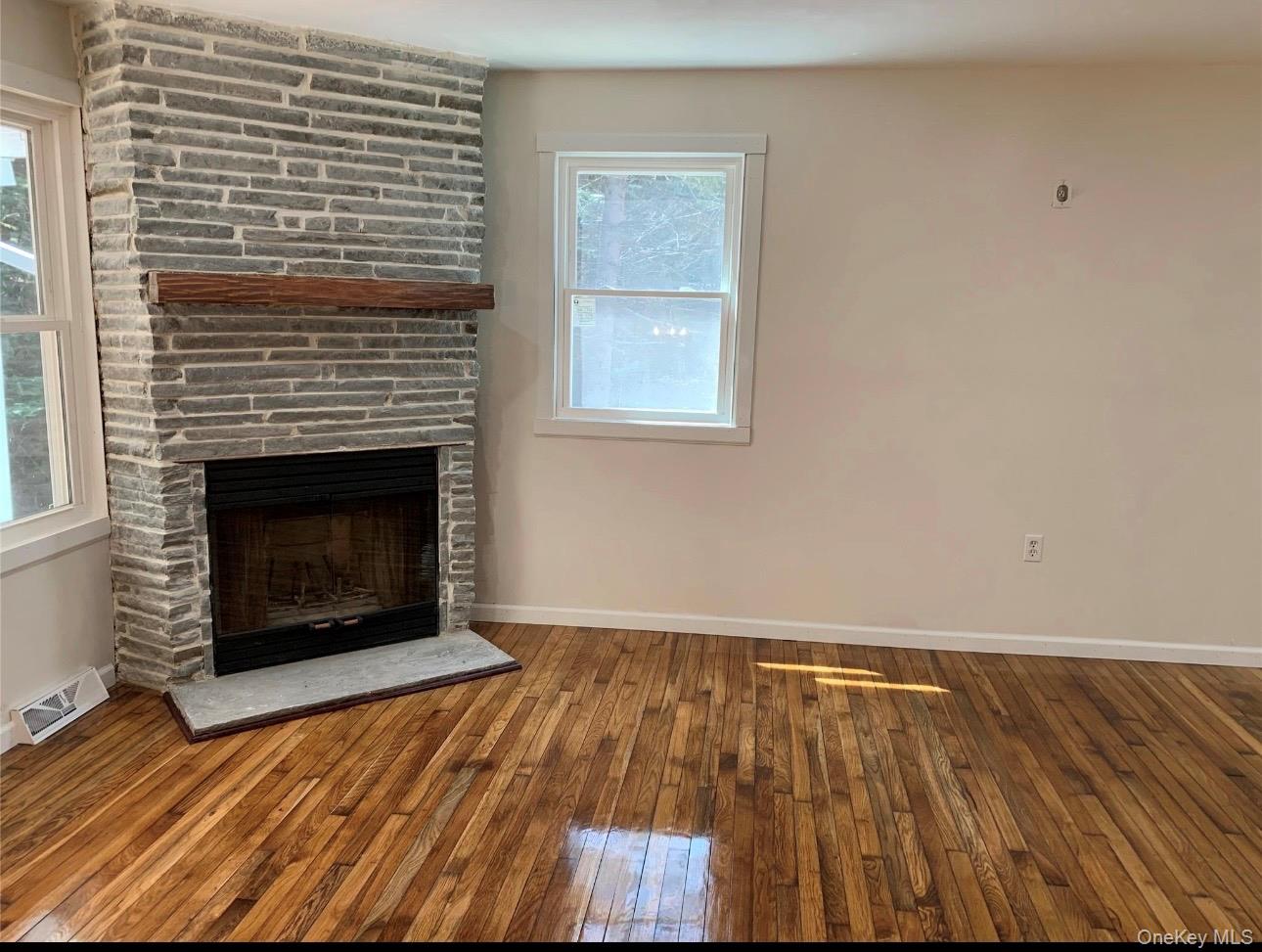 604 Basket Road Long Eddy, NY 12760 - Photo 8 of 37 a view of an empty room with wooden floor fireplace and a window