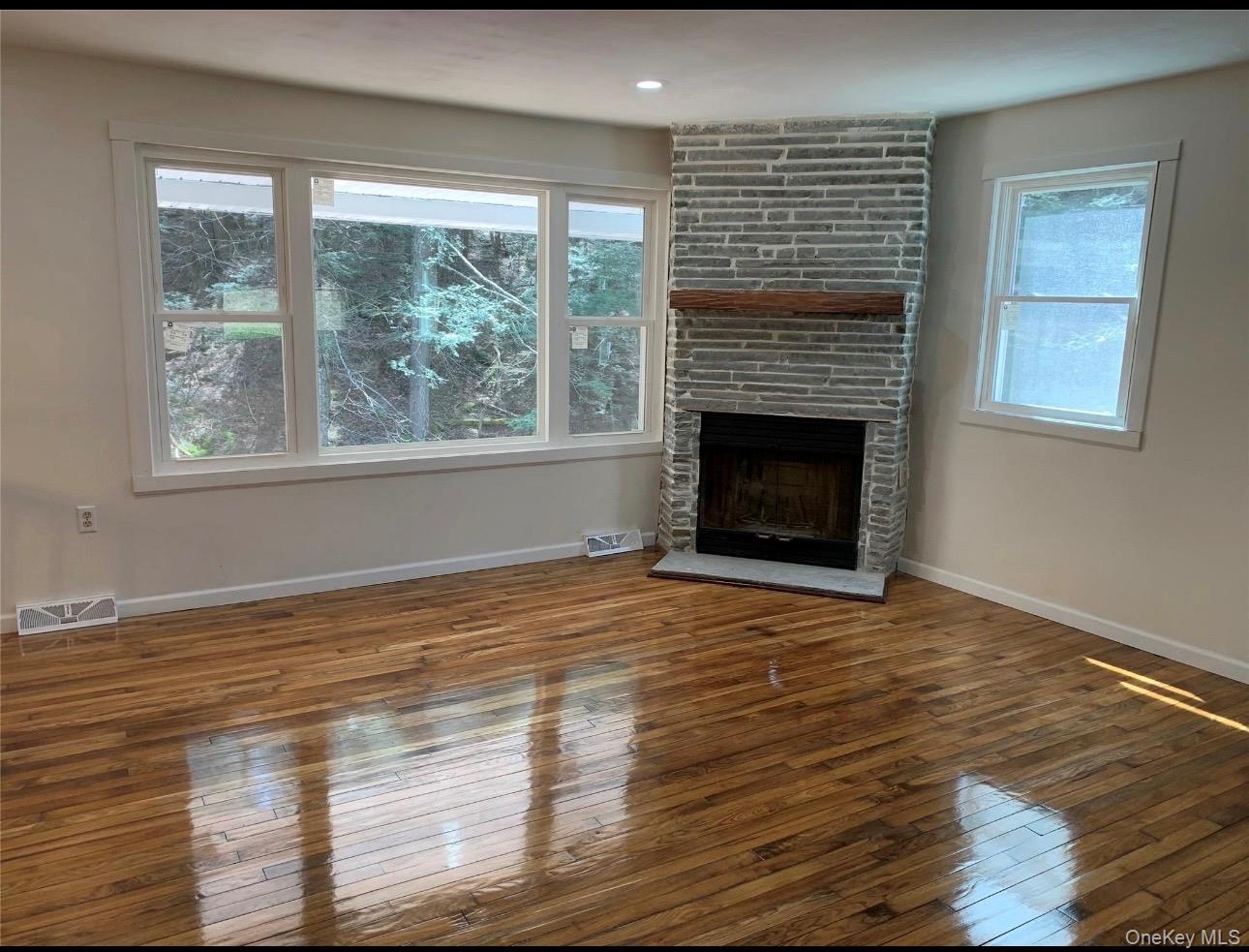 604 Basket Road Long Eddy, NY 12760 - Photo 10 of 37 a view of empty room with wooden floor and a fireplace