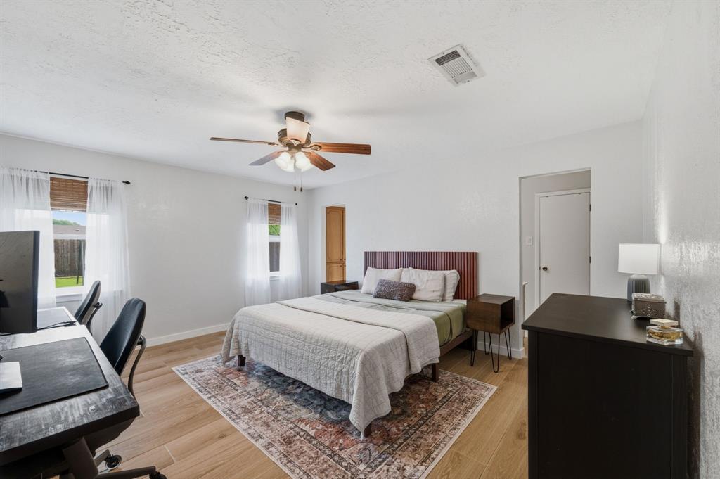 224 Overcrest Drive Benbrook, TX 76126 - Photo 17 of 39 a bedroom with a bed and wooden floor