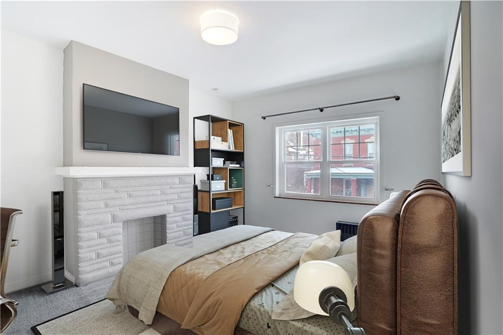 315 Main Street Pittsburgh, PA 15201 - Photo 11 of 23 a bedroom with a bed and a flat screen tv
