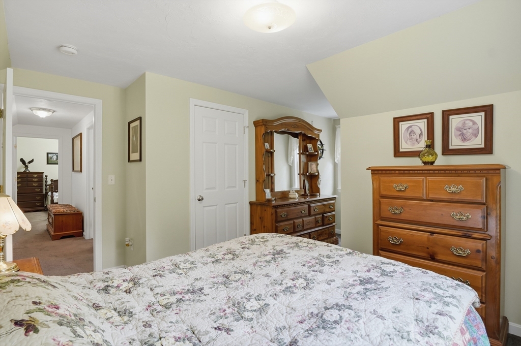 186 Common Street Groton, MA 01450 - Photo 22 of 28 a bedroom with a bed and a dresser in it